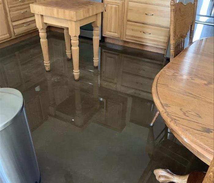 Picture of images reflecting in the water on the kitchen floor